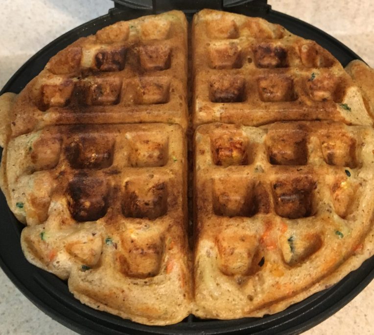 Homemade veggie Belgian waffles with a soft texture, made with vegetables and served on a plate