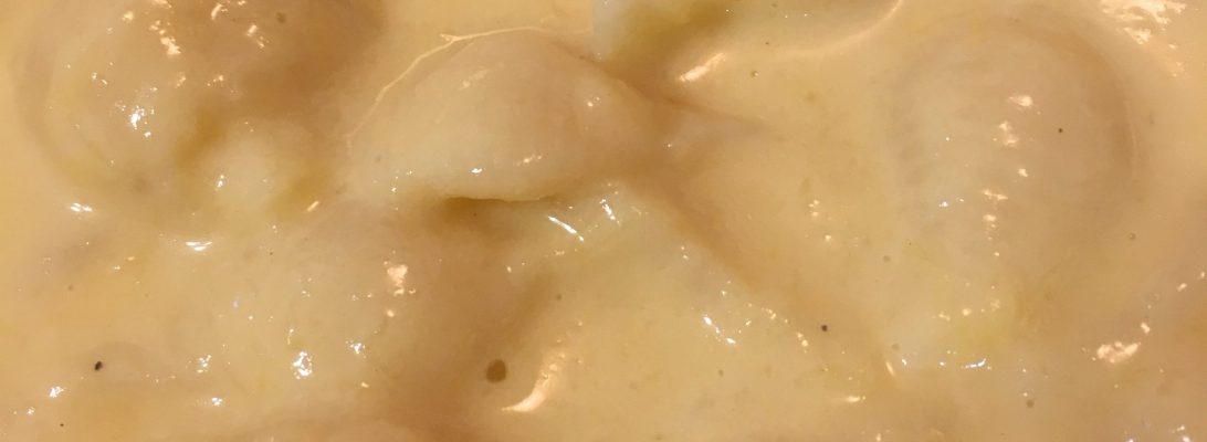 Healthy mac and cheese made with squash, creamy sauce, and pasta in a bow