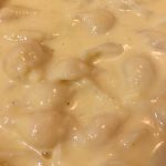 Healthy mac and cheese made with squash, creamy sauce, and pasta in a bow