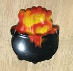 Colorful molded crayons in different shapes made from melted crayons, displayed on a table