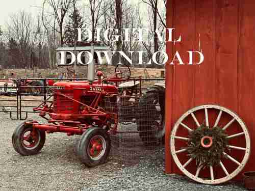 Old tractor parked near a rustic barn in a rural landscape, photographed in natural light